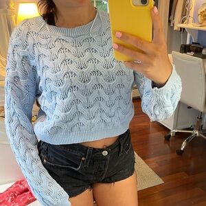 Blue cable knit sweater.